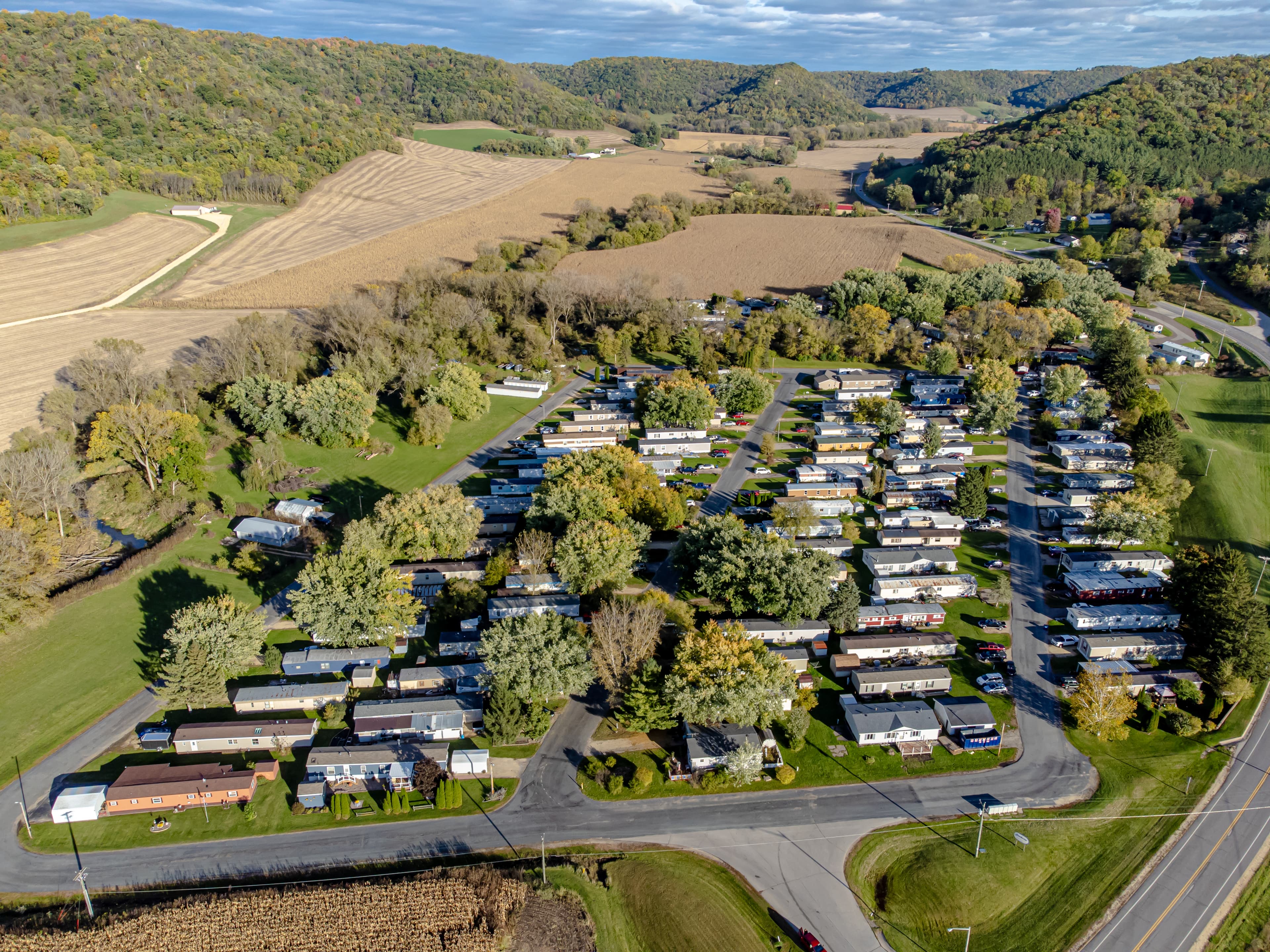 Real aerial photograph of a mobile-home community with rows of homes and internal roads