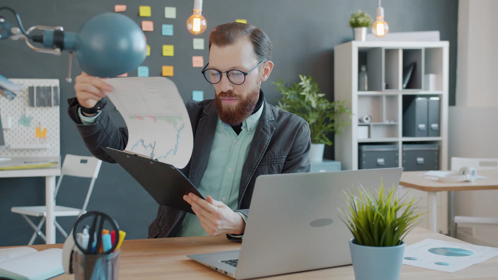 Office professional reviewing charts and reports at a desk
