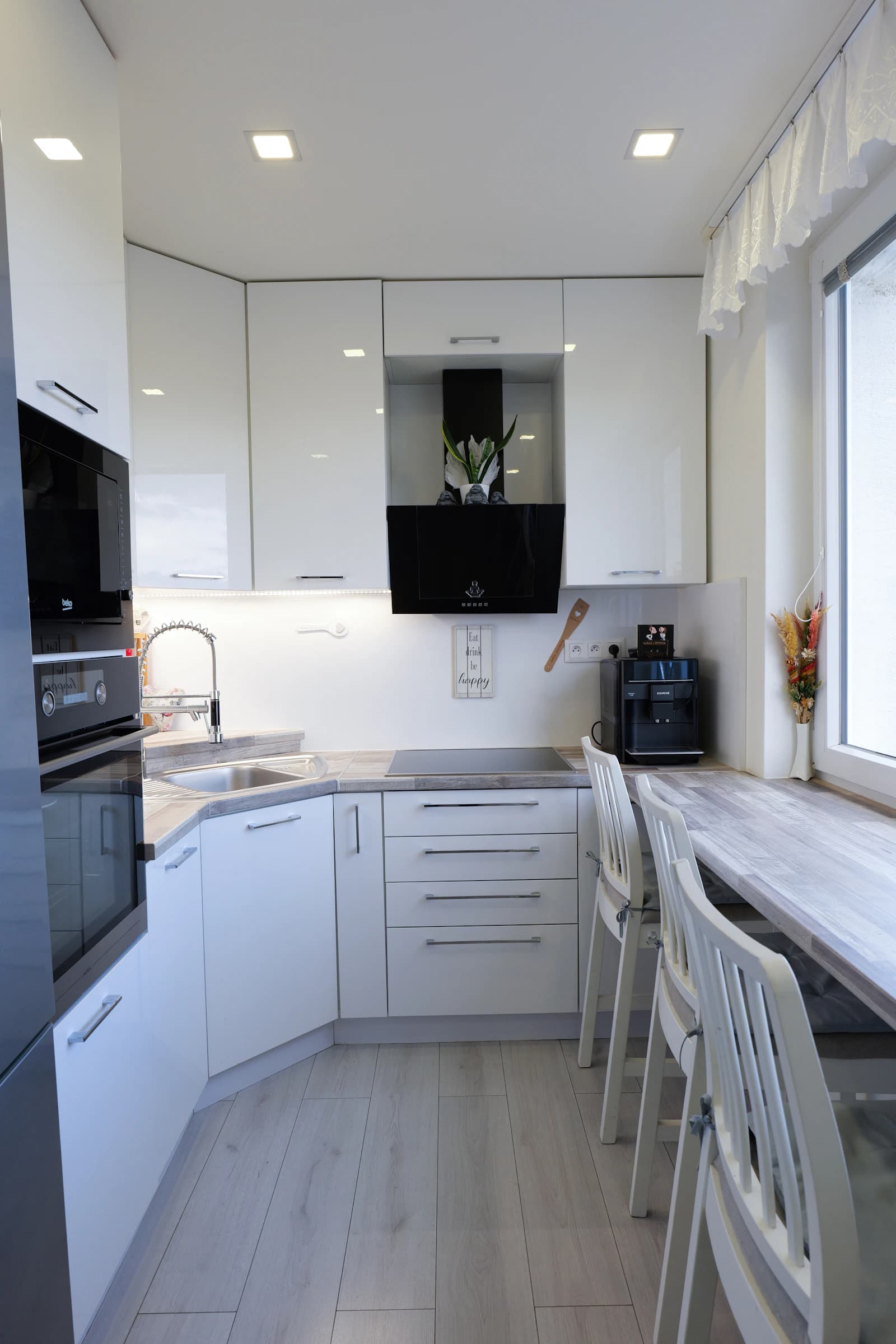 White apartment kitchen with built-in appliances