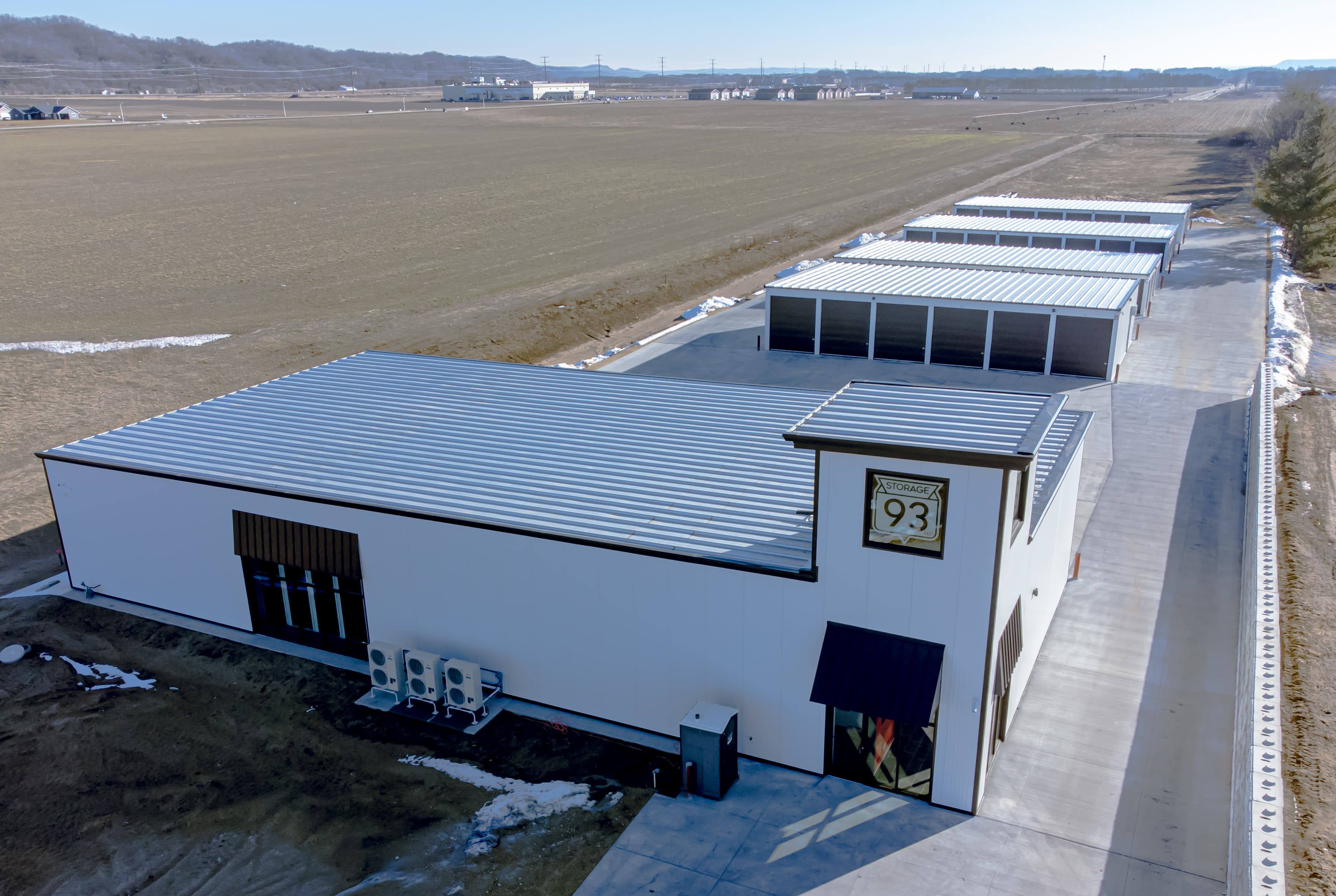 Real aerial photograph of a self-storage office building and rows of storage garages